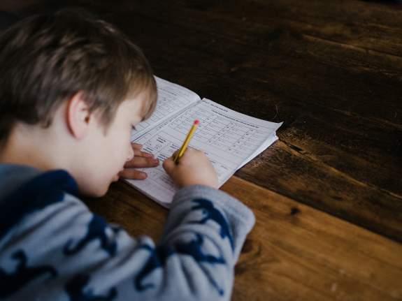Enfant écrivant sur une évaluation.